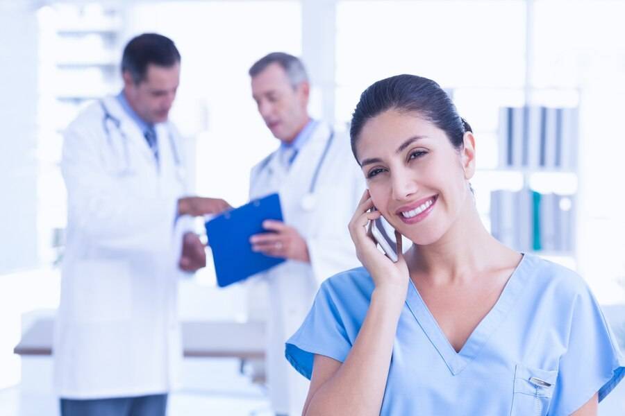 smiling femal doctor phoning 13339 139381